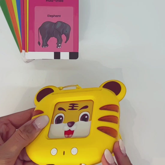 Sheru the Tiger in action — child inserting flashcard into screen-free Indian language learning toy and hearing the word spoken aloud in Gujarati